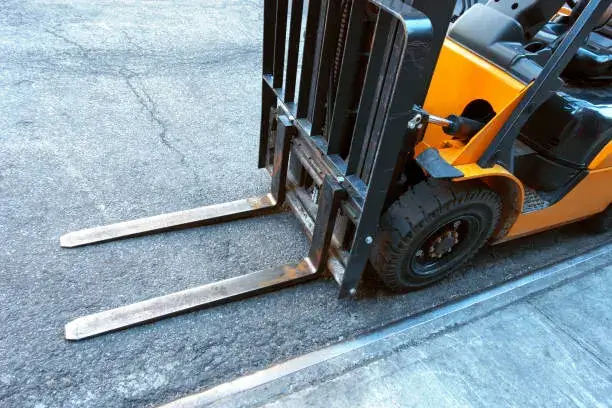 Industrial forklift rental moving heavy loads in a warehouse with high-capacity lifting equipment
