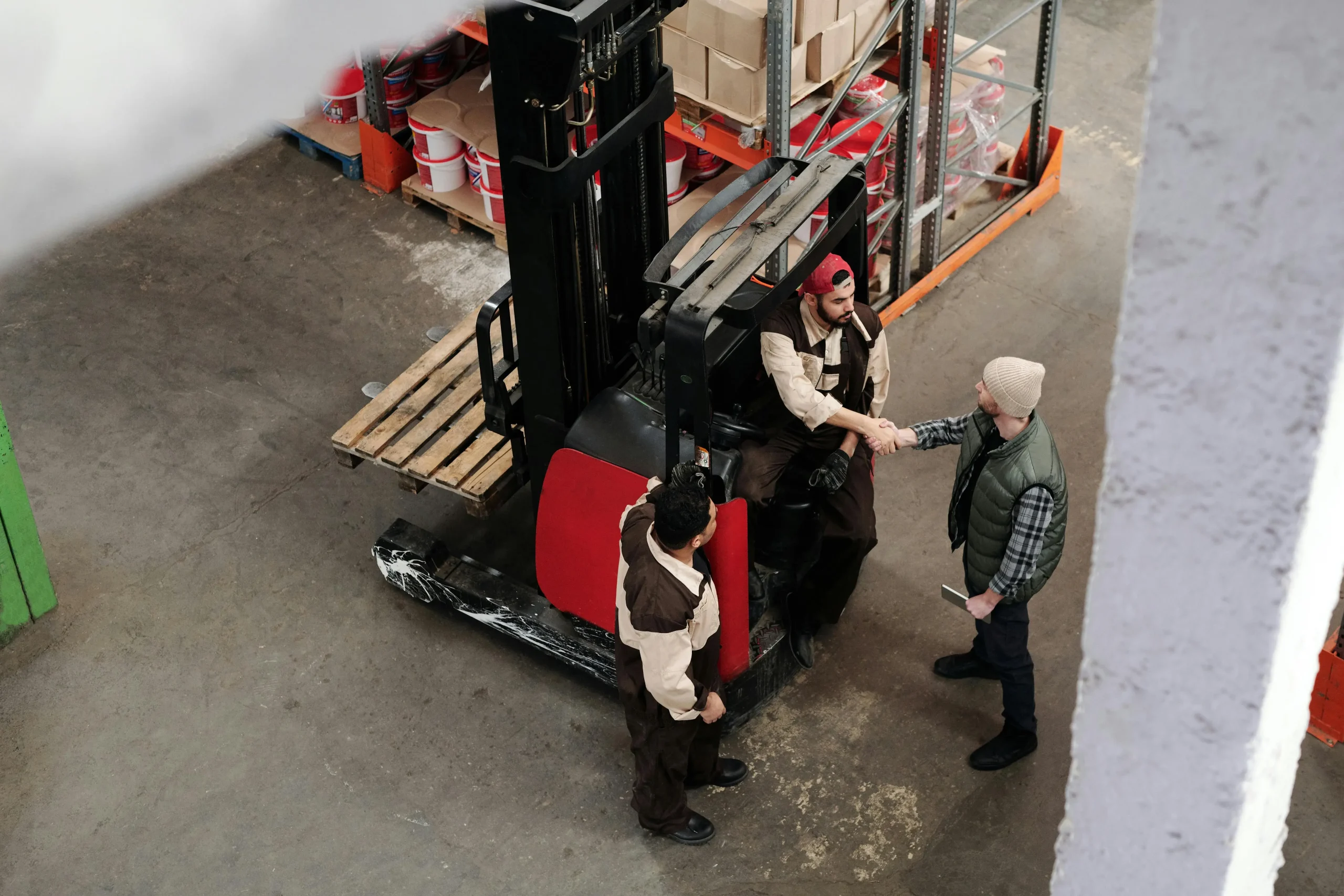 Manual forklift rental pallet jack being used to move boxes in a warehouse setting